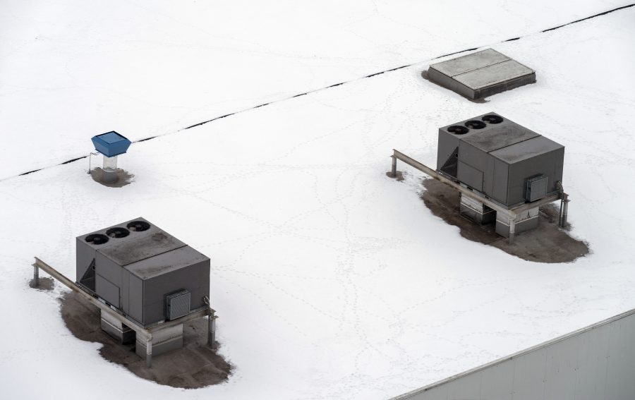 snow on roof of commercial building in winter